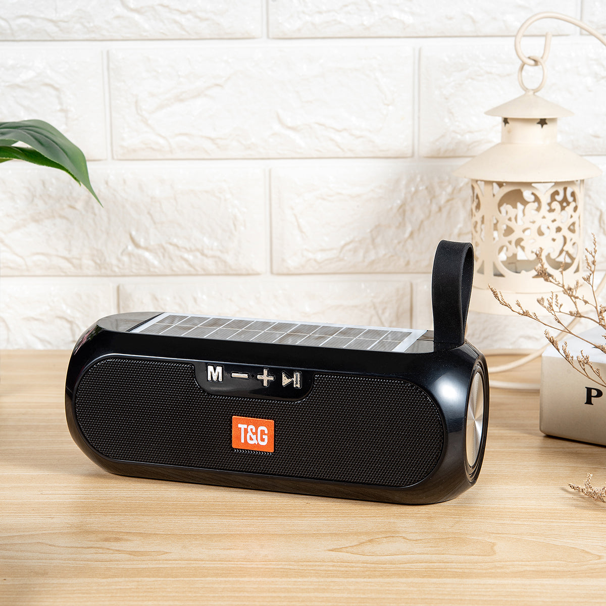 T&G TG182 Portable Solar Power Wireless Speaker with solar panel on top, black design, and control buttons, ideal for outdoor audio use.